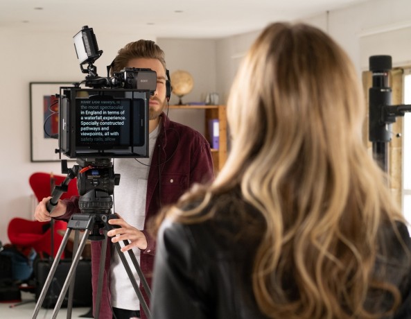 Filming presenter using teleprompter