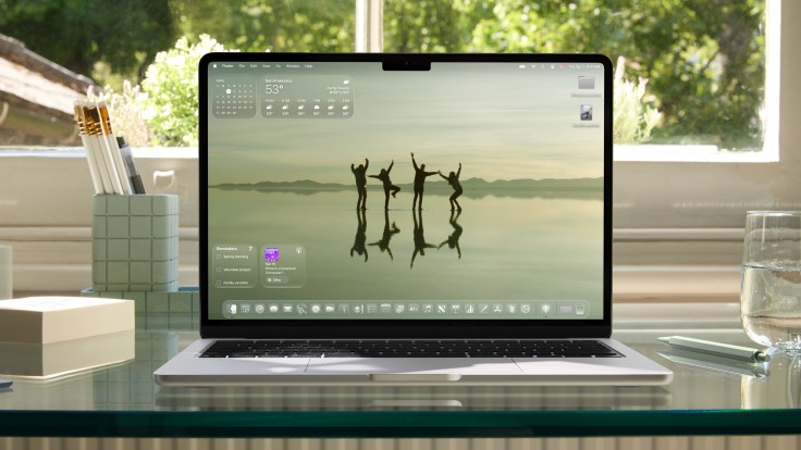 MacBook with redesigned macOS home screen and transparent widgets