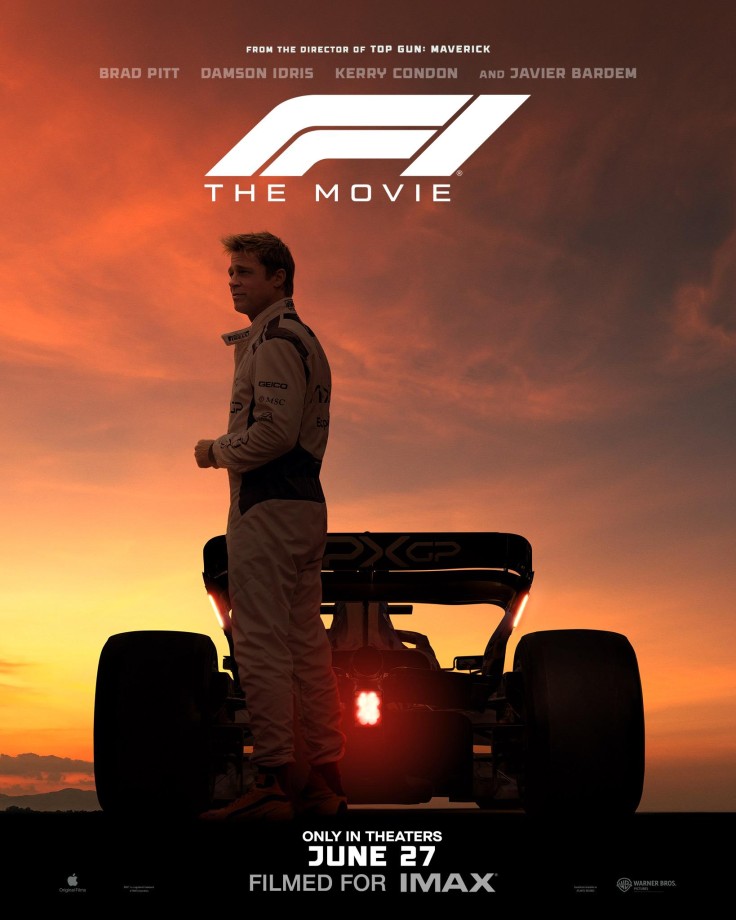 Brad Pitt stands beside F1 car at sunset in movie