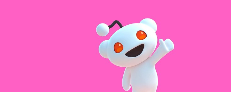 Reddit’s Snoo mascot waving on a bright pink background