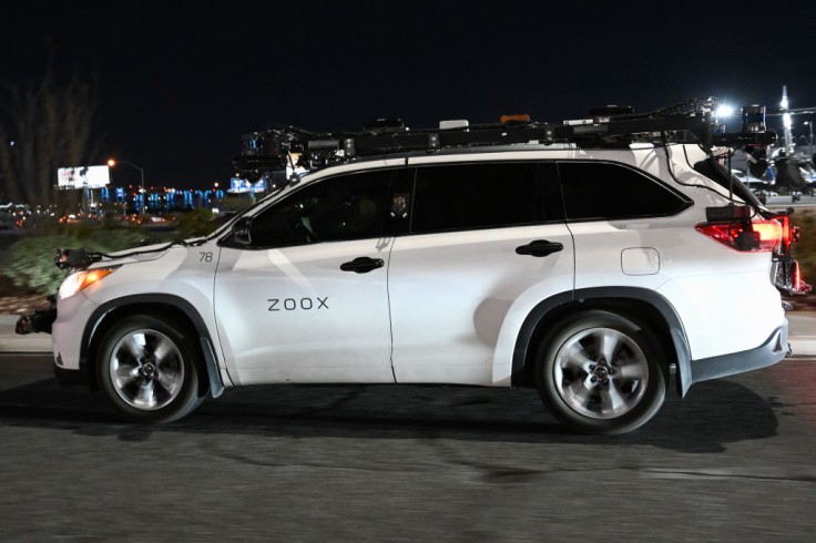 Zoox test vehicle outfitted with sensors driving at nightA Zoox