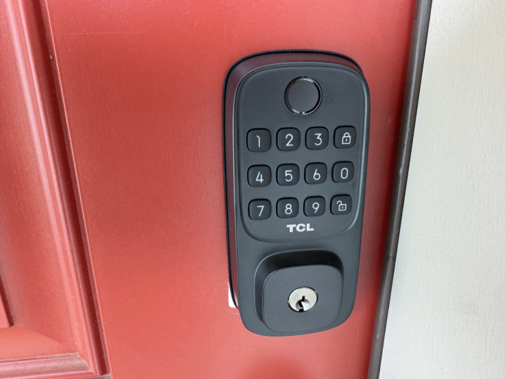 TCL D1 smart lock installed on red door