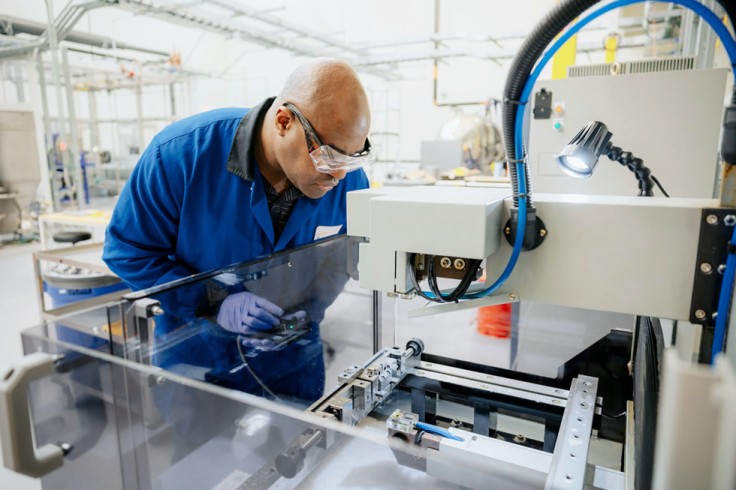 Technician inspects magnet recycling machine