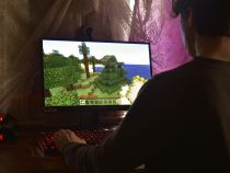 guy on computer playing minecraft