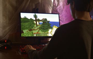 guy on computer playing minecraft