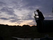 Armin Küpper playing his saxophone on a pipeline